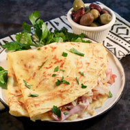 Crepe stuffed with ham, mushrooms, cheese, blue sauce